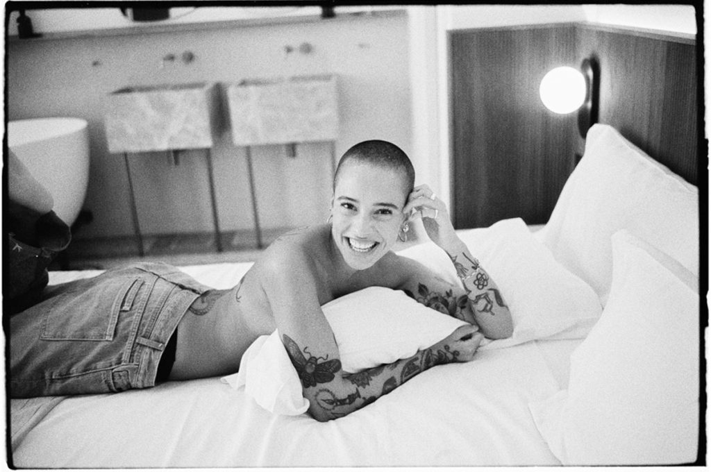 Black and white portrait of a woman on a bed