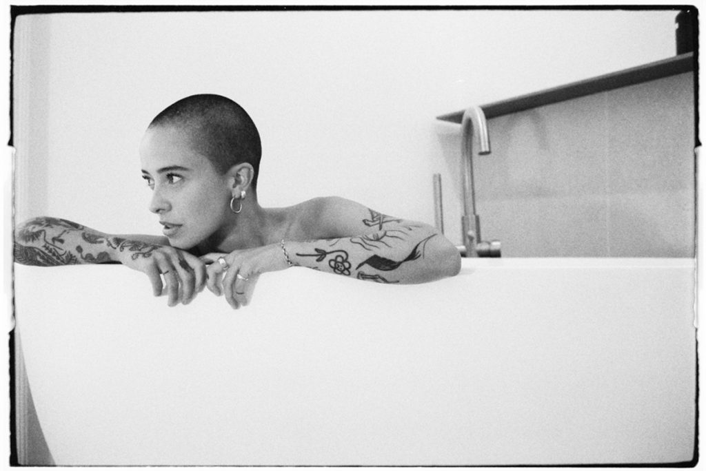Black and white portrait of a woman in the bath tub