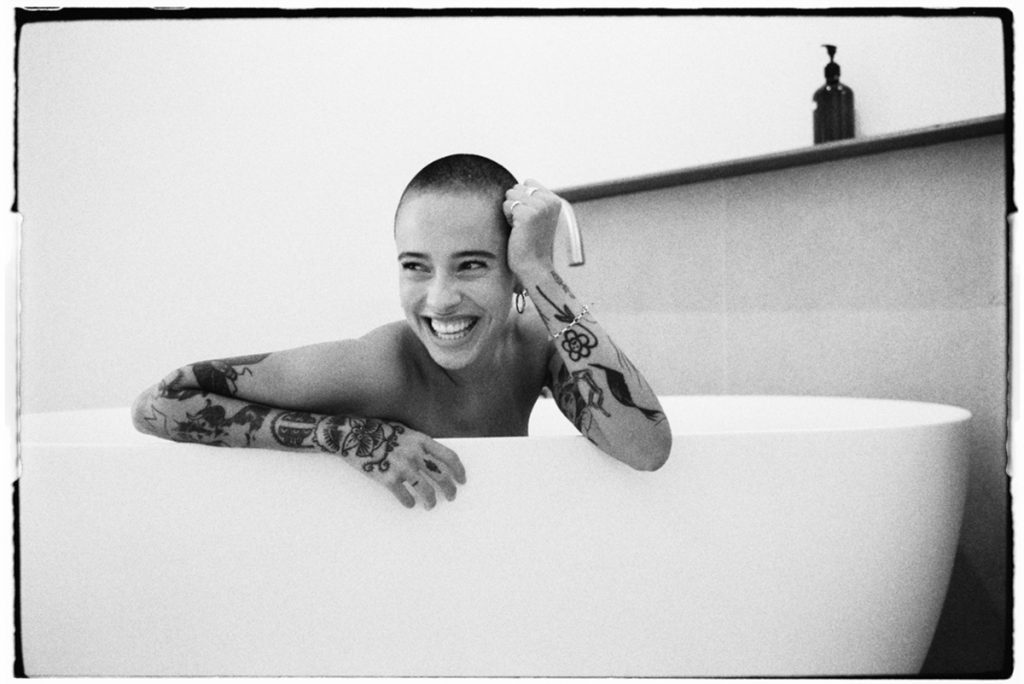 Black and white portrait of a woman in the bath tub