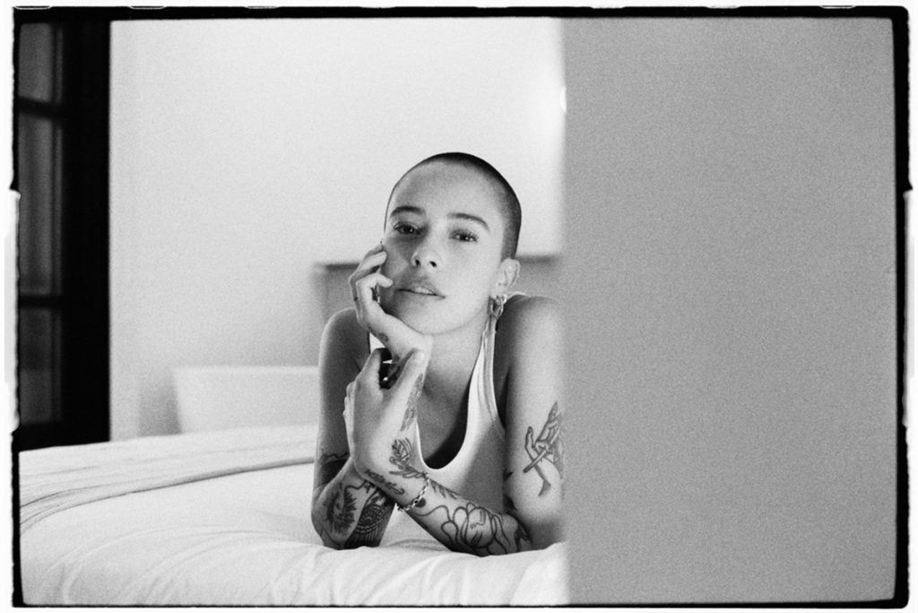 Black and white portrait of a woman on a bed