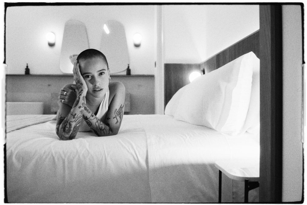 Black and white portrait of a woman on a bed