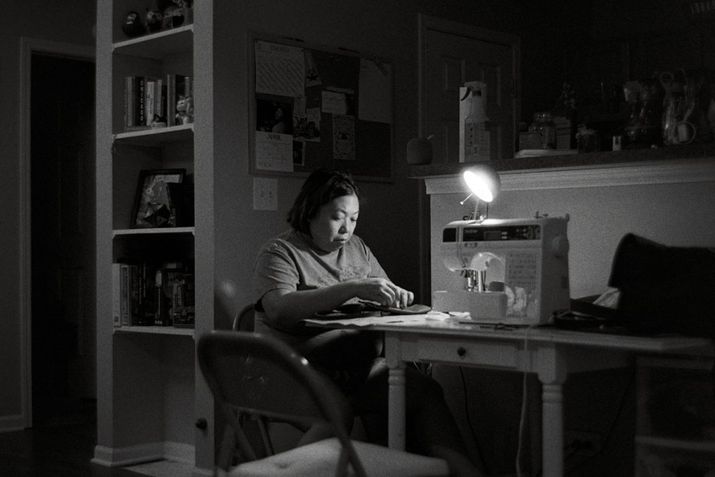 Black and white picture of a woman sat at a desk