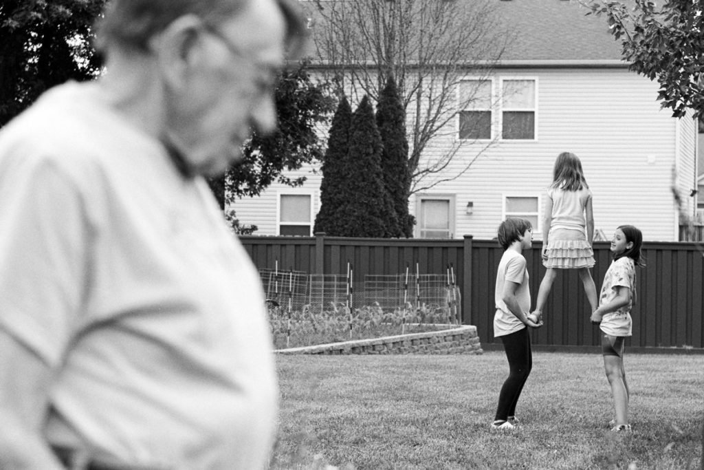 Black and white picture of a family having fun in the garden