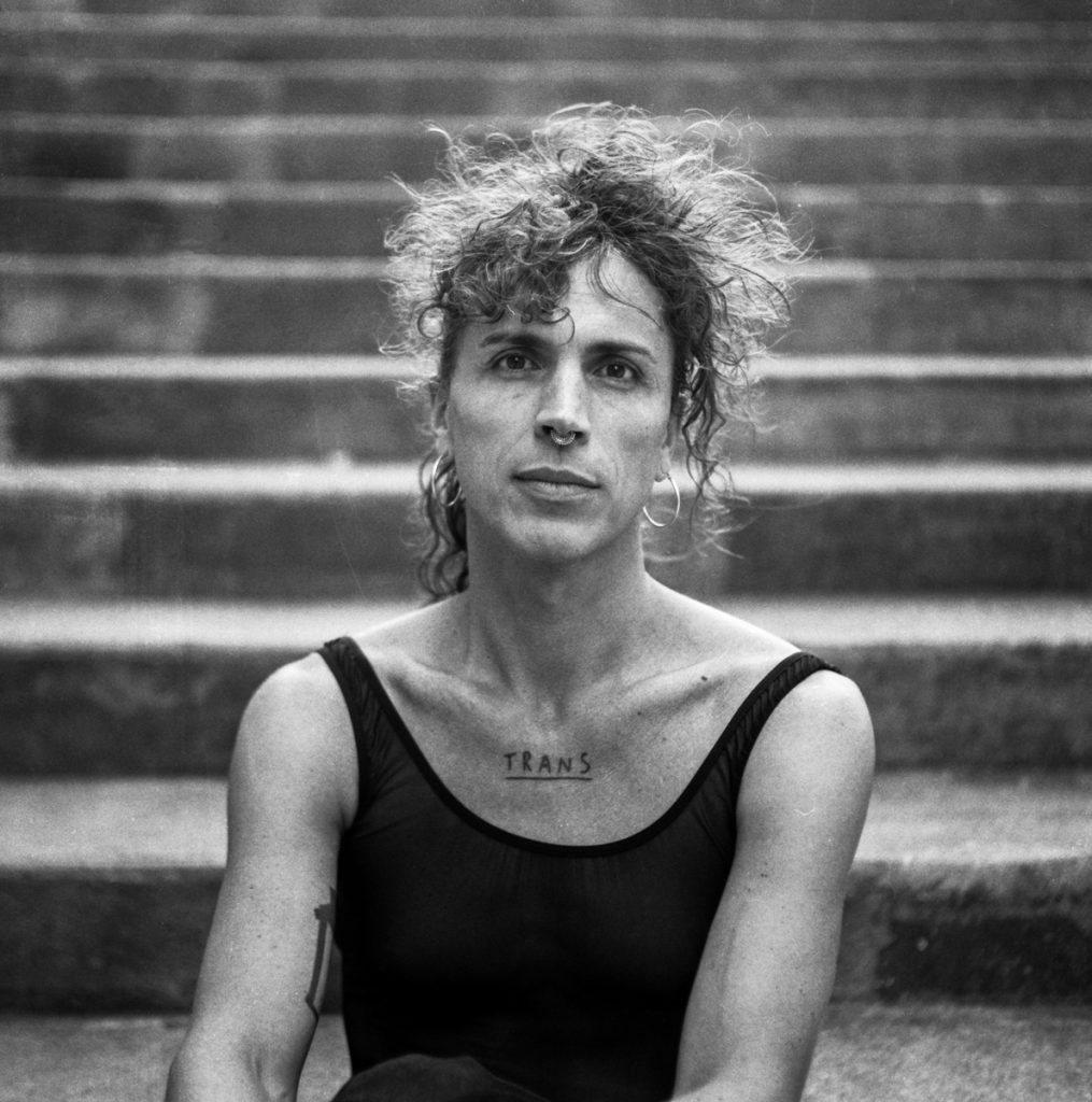 Trans woman sat on a step