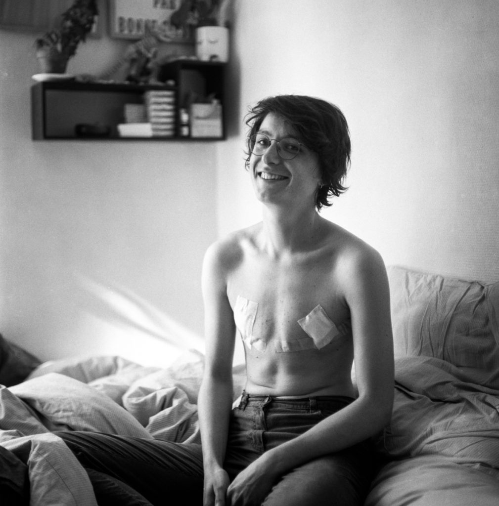 Female woman sat on a bed