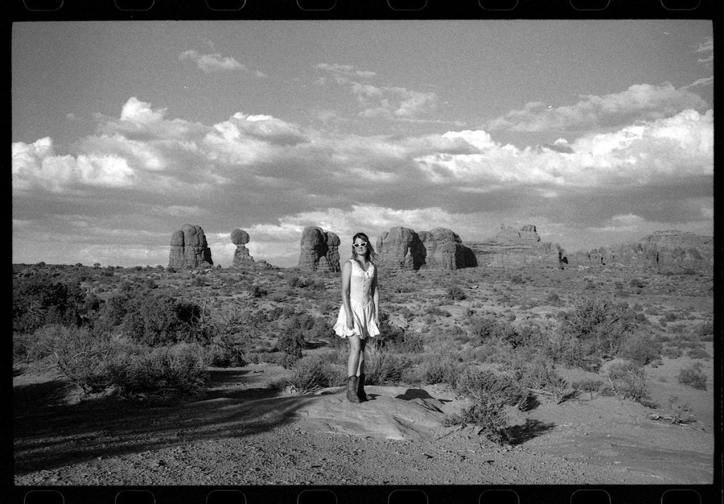 Black and white picture of a woman in a desert