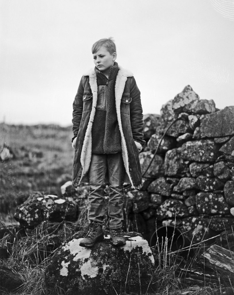 boy stood on a rock