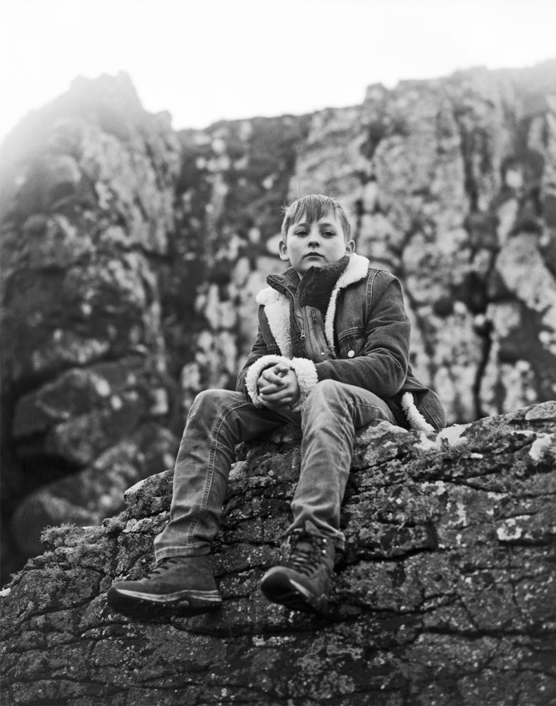 Boy sat on a rock