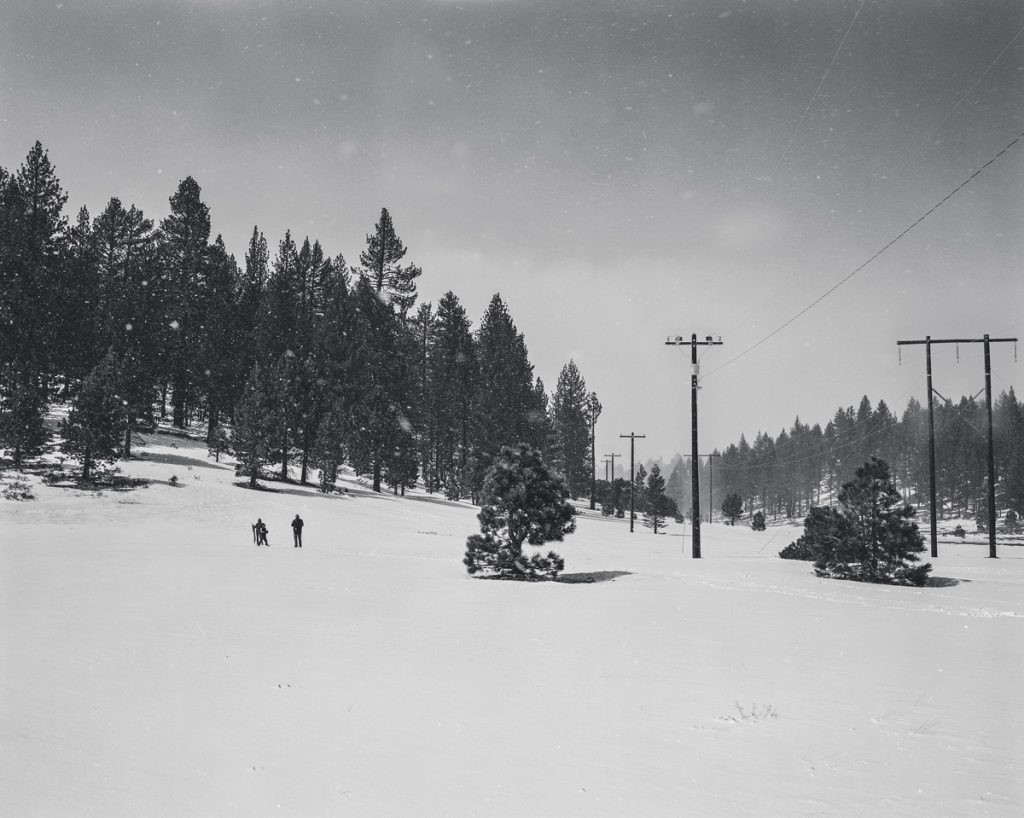 Black and white white picture of snow at a ski resort