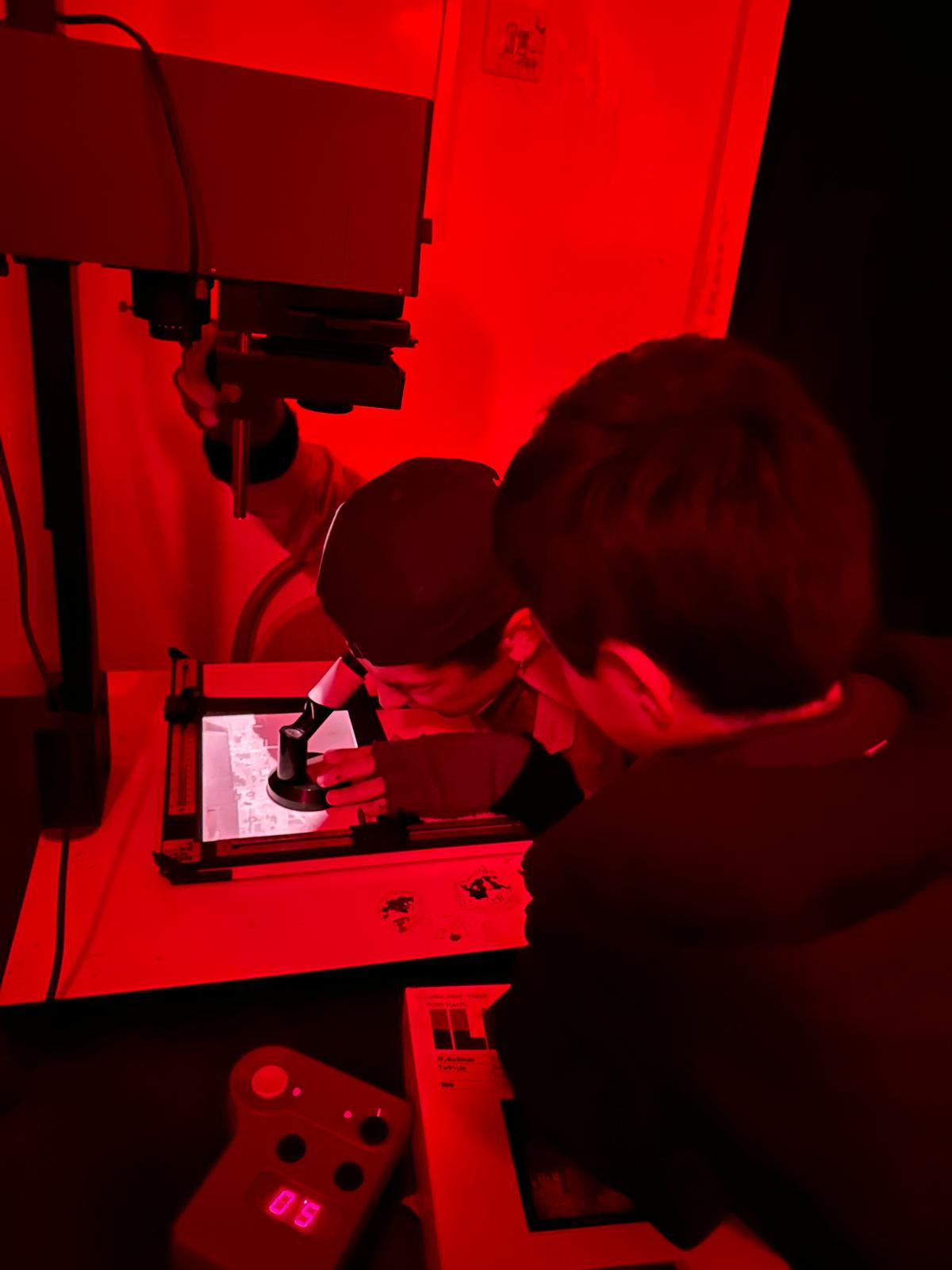 Children learning in the darkroom at Fotohane Darkroom