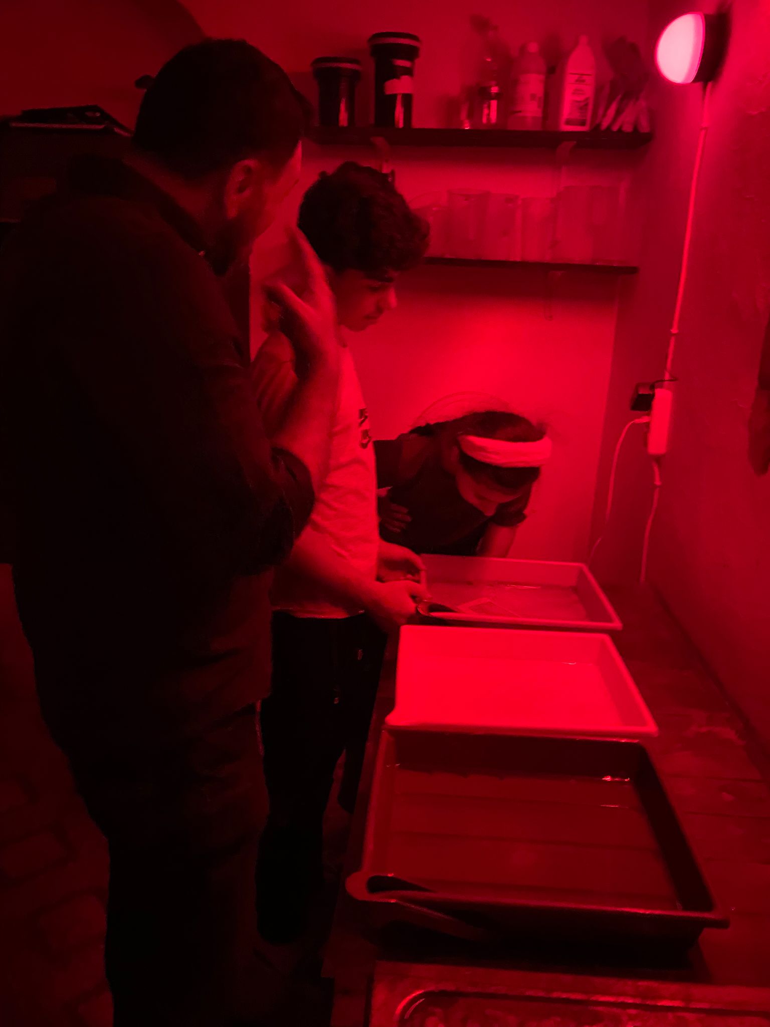 Children learning in the darkroom at Fotohane Darkroom