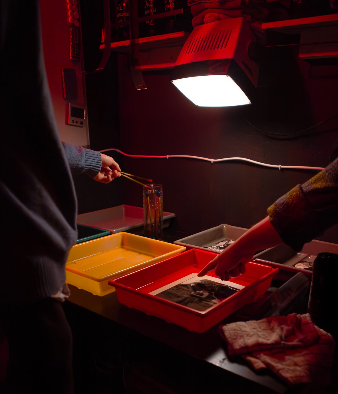 Darkroom prints being developed at Negative Development community darkroom